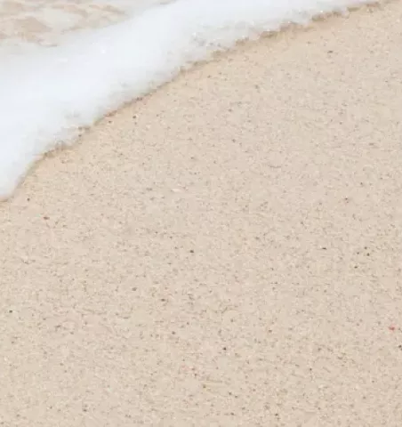 Vague qui revient sur une plage de sable